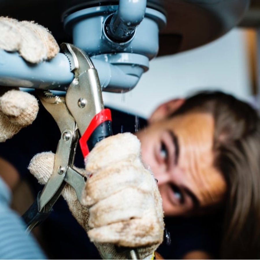 Professional plumbing company Olivehurst CA technician repairing residential pipes